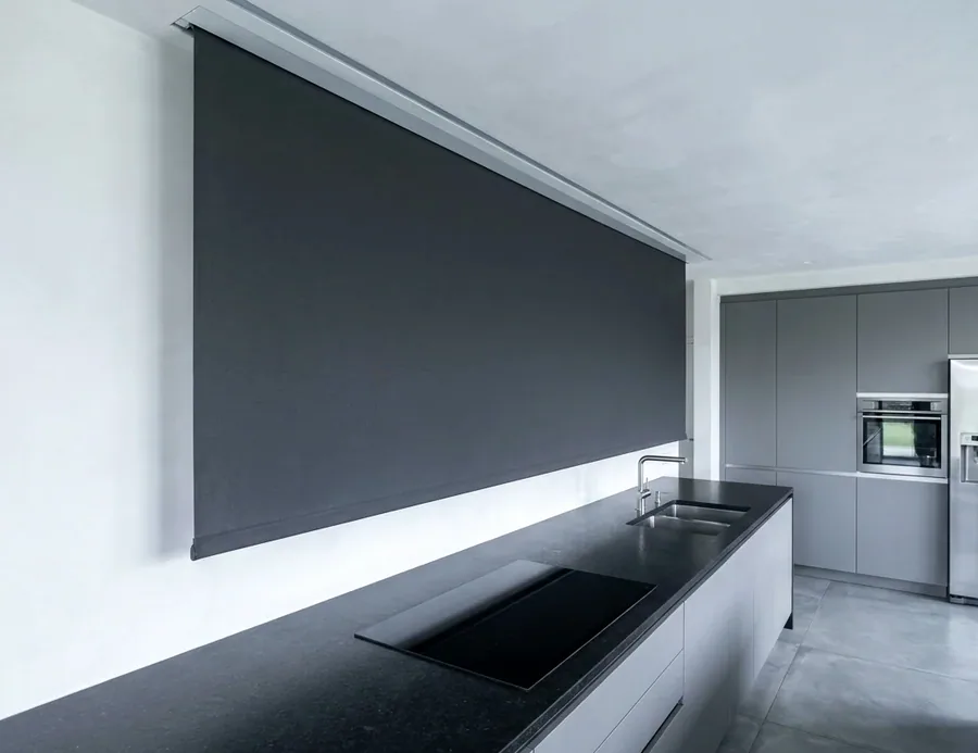 Recessed blind fabric dropping from a slim ceiling slot with no visible hardware