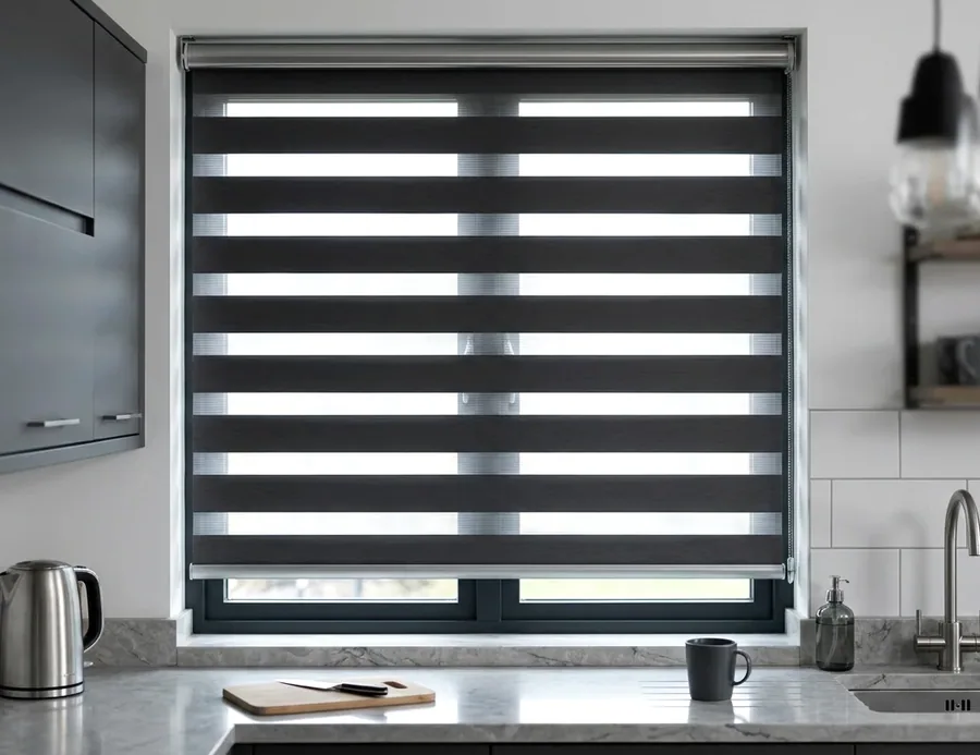 Day and night blind with alternating sheer and solid fabric bands over a kitchen window